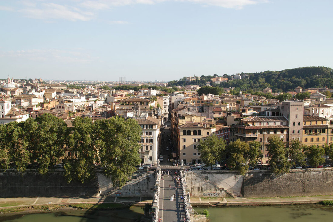 View of the city of Rome with buildings and trees across the river