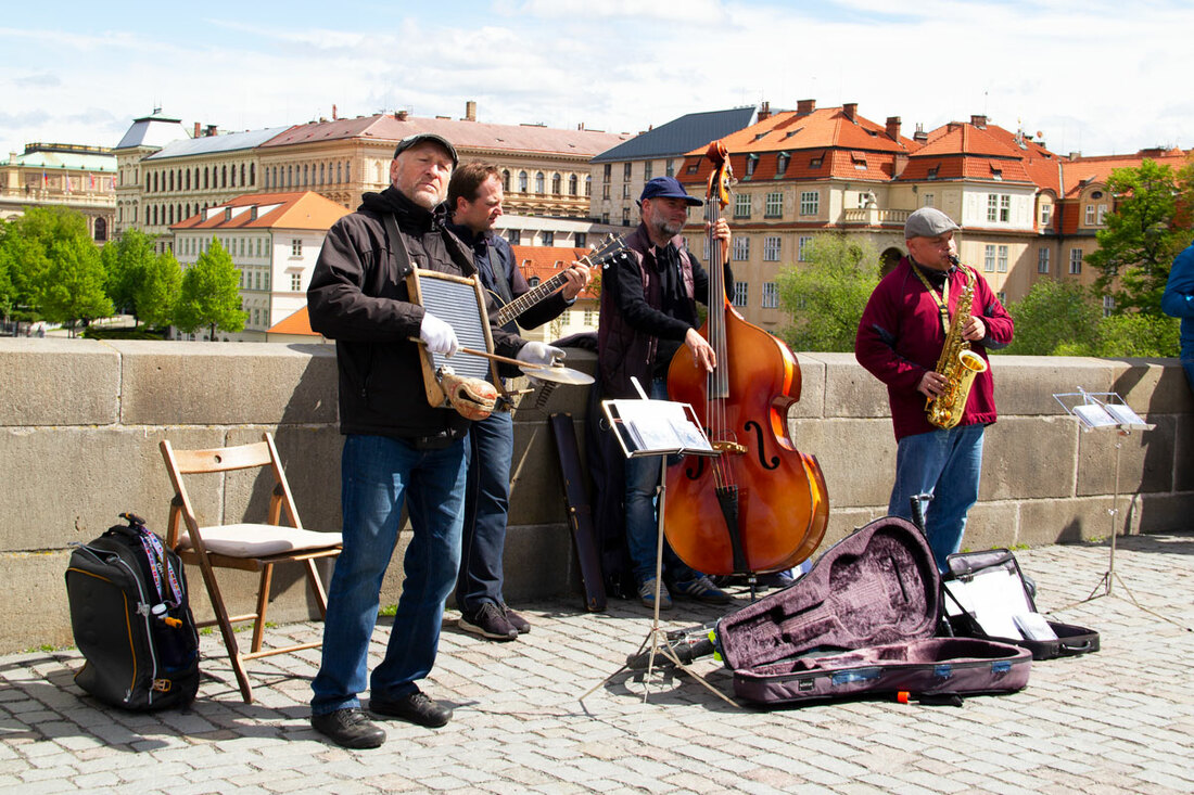 Musicians performing on a bridge with guitar case in front of them