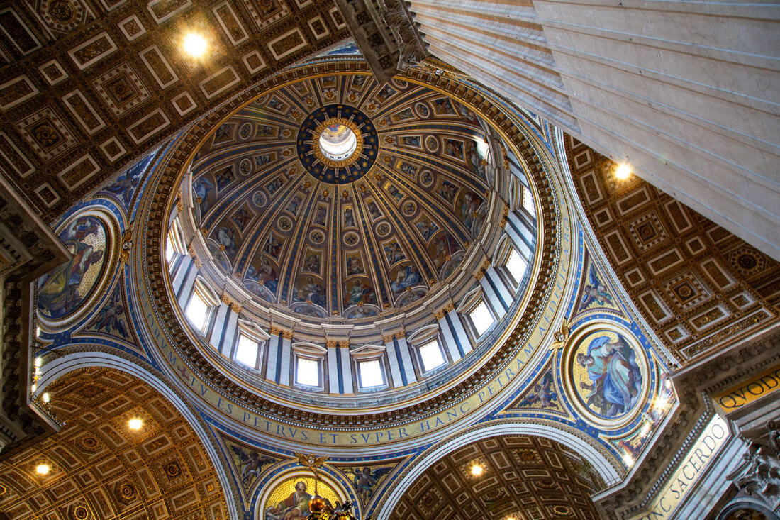 The ceiling of St Peter's Basilica with gold and blue decoration