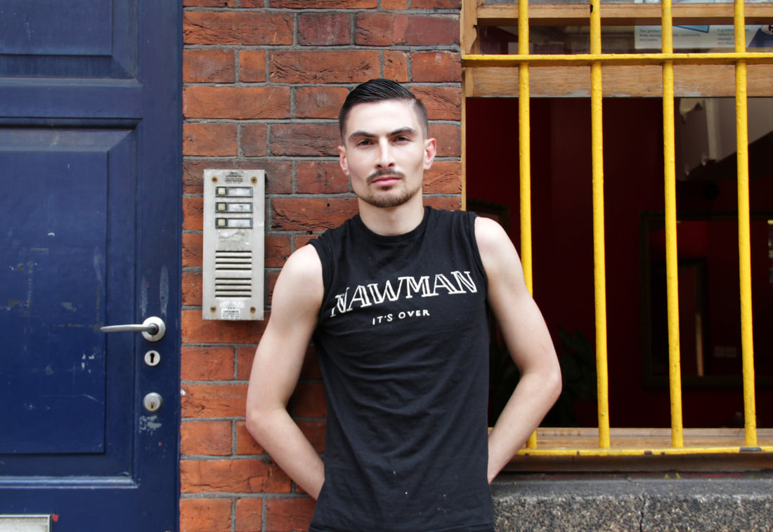 Male model on the street of London with yellow window shield and blue door