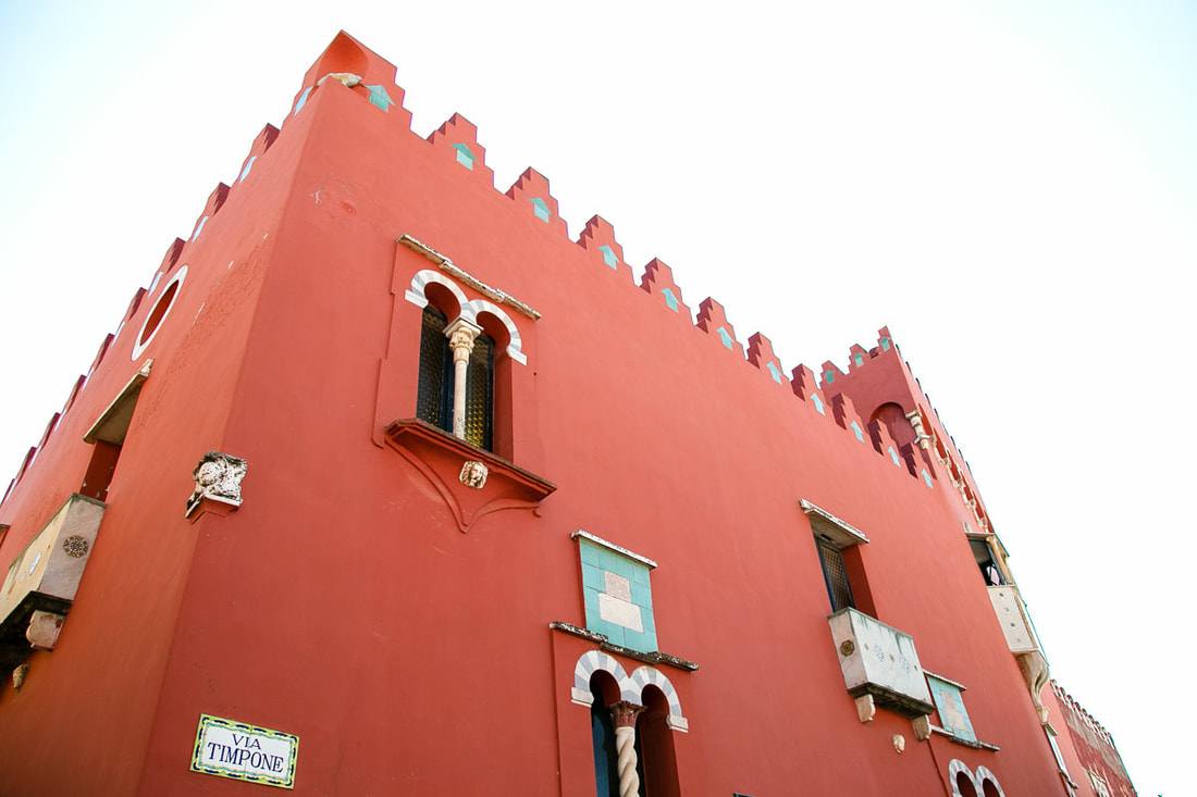 A red building with white decoration on the windows