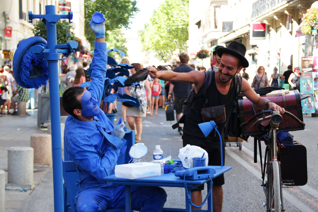 Artists interact on the street of Avignon during the festival.