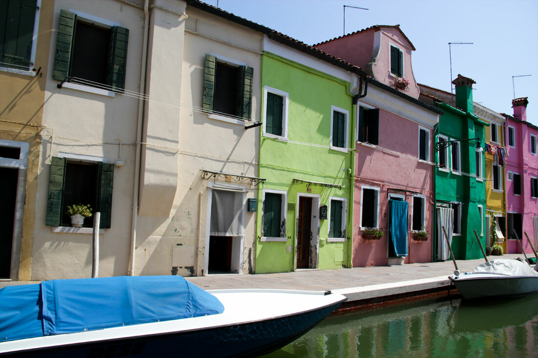 Colourful fisherman houses besides the river in Burano.