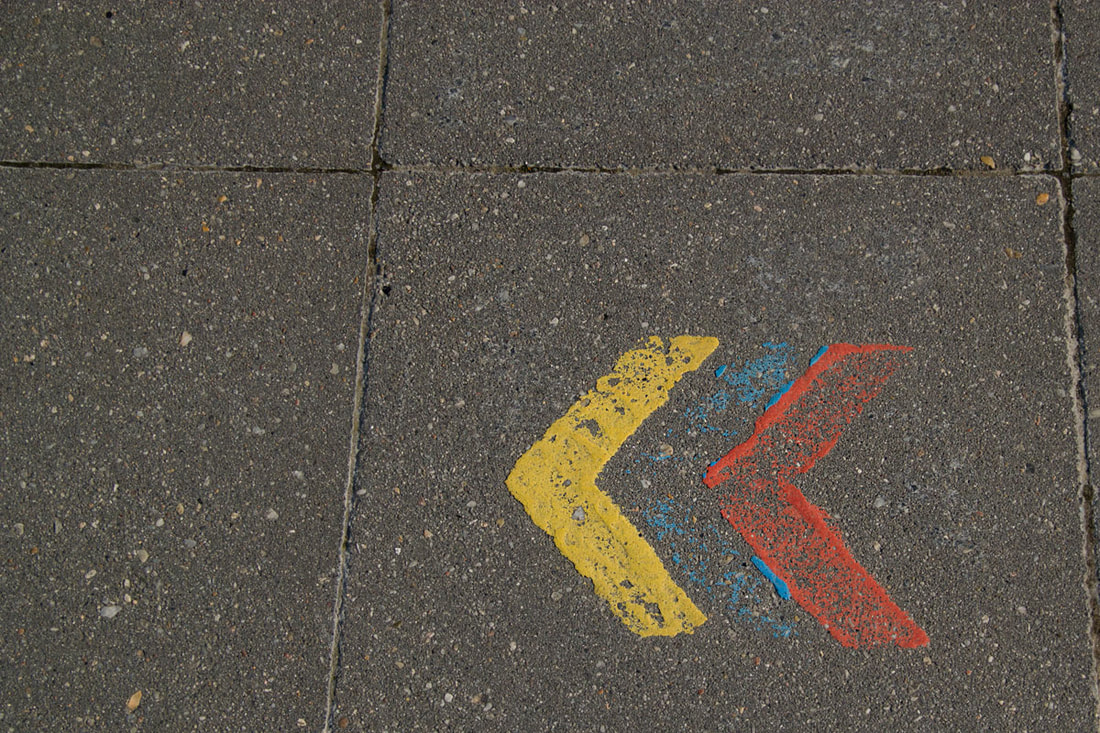 Yellow, red and blue arrows painted on the floor.