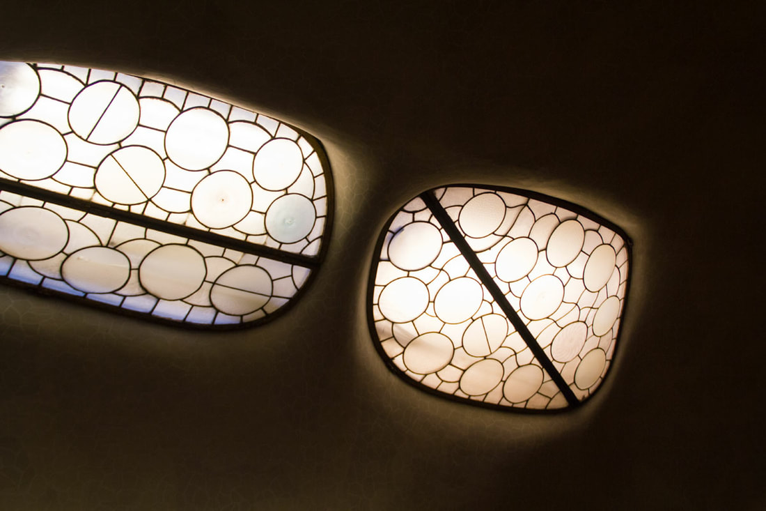 Two lights with circles and lines carved design mount in the ceiling.