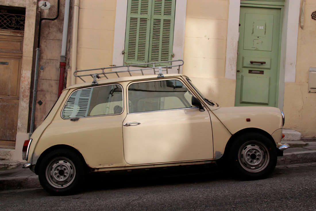 Matching yellow car and wall in the street of Marseille.