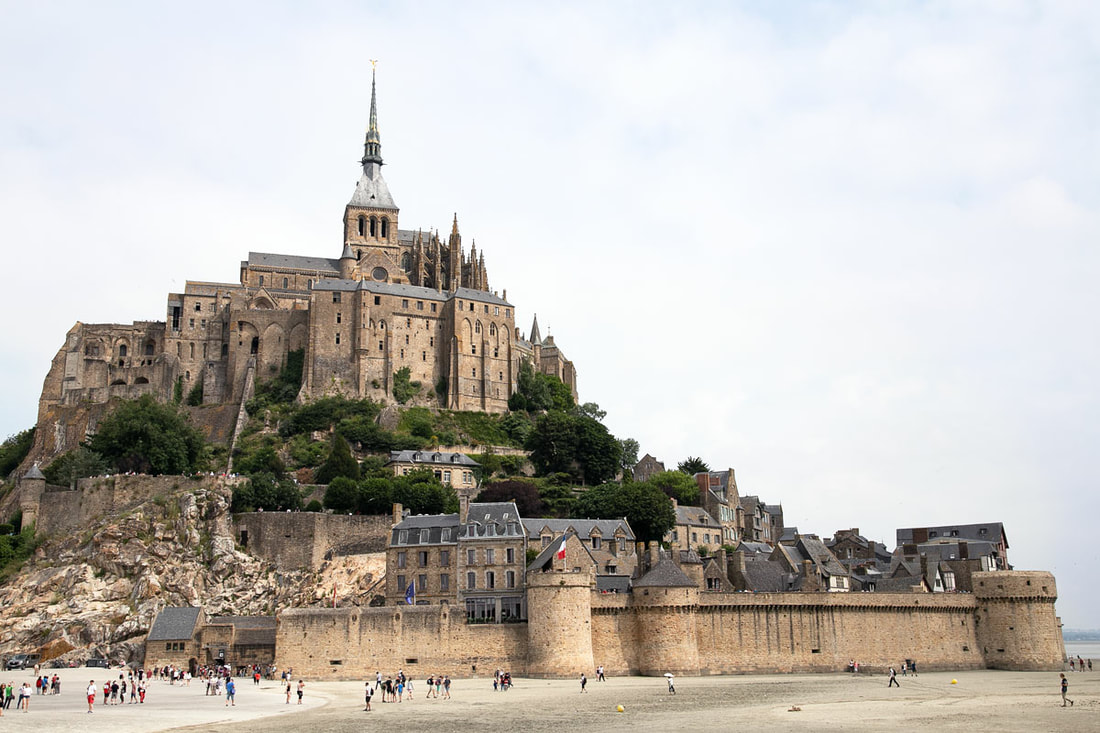 The view of the Mont-Saint-Michel surrounds by the sand. 