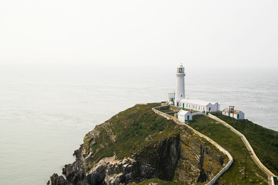 A distance view of South Stack Lighthouse by the seaside on the Holy Island, Anglesey, Wales. 